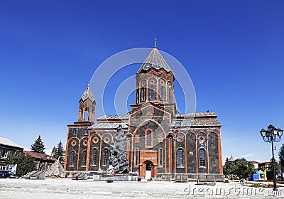 View of the Armenian Apostolic Church of the Holy Saviour and the monument to those killed in the devastating earthquake of 1988. Editorial Stock Photo
