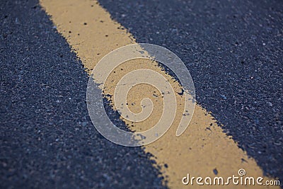 View of asphalt with distinct two yellow stripes Stock Photo
