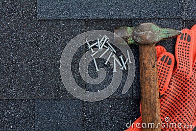 View on Asphalt Roofing Shingles Background. Roof Shingles - Roofing. Asphalt Roofing Shingles Hammer, Gloves and Nails Stock Photo