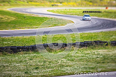 View of autodrome race circuit racetrack with a line of cars driving and racing, with audience and during rally autocross racing Stock Photo