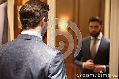 View from back of bearded man looking at the mirror Stock Photo