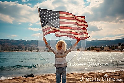 View from the back child holds the American flag of the USA on the background of the lake Stock Photo