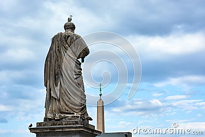 A view of the back of the sculpture of Saint Peter and obelisk at Saint Peter`s Square in the Vatican City in Rome, Italy Stock Photo