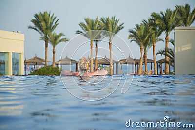 View from back of white european tourist swimming in blue water Stock Photo