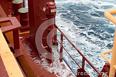 View of Ballast Water exchange process onboard of a ship using flow-through method underway in open ocean. Overflow method through Stock Photo