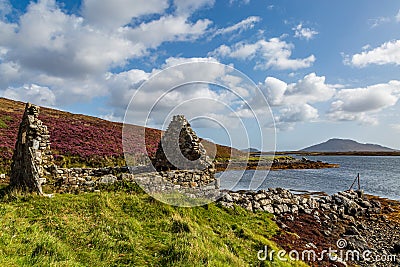 A View from the Bank of Loch Langass on the Hebridean Island of North Uist, with Heather on the Hills and Ruins in the Foreground Stock Photo