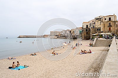 View of the beach of Cefalu with the old city in the background Editorial Stock Photo