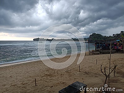 view of the beach wide waters and overcast clouds Stock Photo