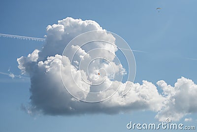 beatiful cumulo nimbus cloud .with paragliders on blue sky background Stock Photo