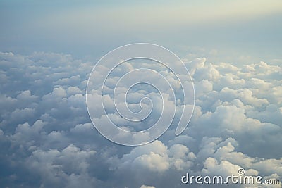 View of beautiful dreamy fluffy abstract white cloud with blue sky and sunrise light background from airplane window Stock Photo