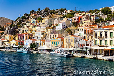 View of the beautiful greek island of Symi (Simi) with colourful houses and small boats. Greece, Symi island Stock Photo