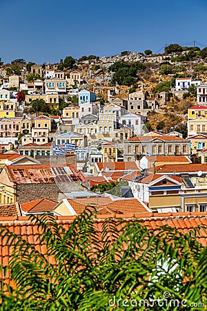 View of the beautiful greek island of Symi (Simi) with colourful houses and small boats. Greece, Symi island Stock Photo