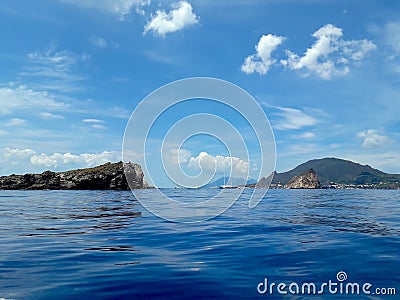 View of beautiful scenery at Italy with yachts, sailing boats. Turquoise and dark blue sea some mountains and vegetation Stock Photo