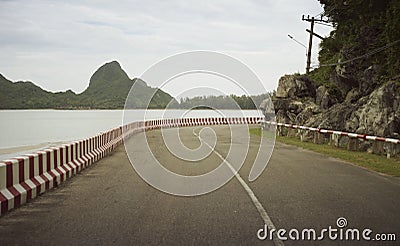View of beautiful turning road near the sea and mountain,abstract vintage filtered image. Stock Photo
