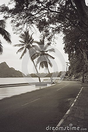 View of beautiful turning road near the sea and mountain,abstract vintage monotone filtered image. Stock Photo