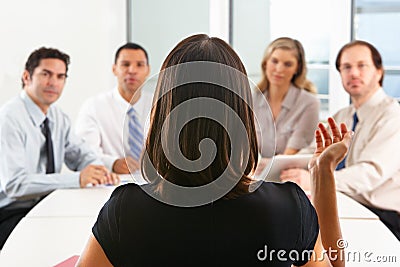 View From Behind As CEO Addresses Meeting Stock Photo