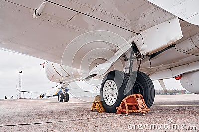 View from below. Turboprop aircraft parked on the runway at daytime Stock Photo