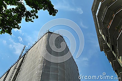 View from below of wrapped residential building for restoration Stock Photo