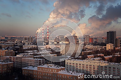 View of the big city from above. Smoking chimneys of boiler rooms on the background of the cityscape Stock Photo