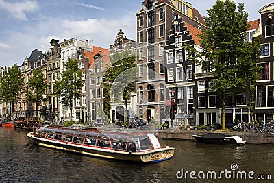 View of a big cruise canal tour boat, trees Editorial Stock Photo