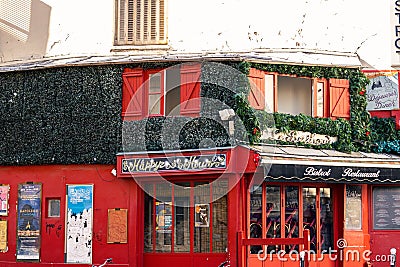 View of Bistrot restaurant's red exterior in Paris, France Editorial Stock Photo