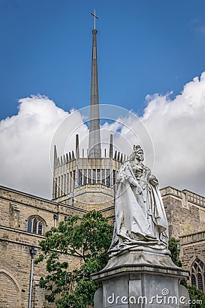 A view of Blackburn cathedral with statue of Queen Victoria Stock Photo