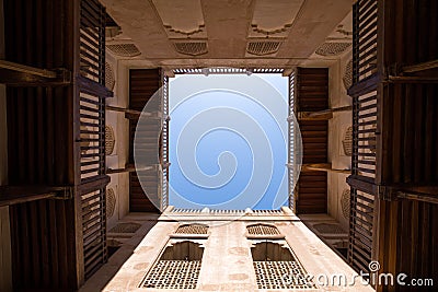 View of a blue sky through a traditional Omani house courtyard. Stock Photo