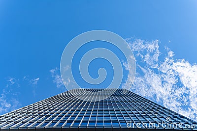 View from the bottom of office tower skycrapper building with glass windows in cloud blue sky Stock Photo