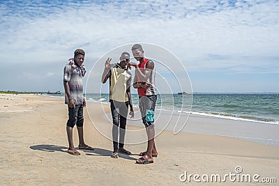 View of boys in posing for photography on the beach next to ships graveyard Editorial Stock Photo