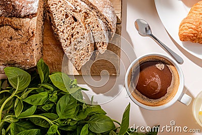 View of bread, basil and cup Stock Photo