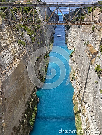 View from the bridge to the boats and yachts passing through the Corinth Canal from a sunny day on Peloponnese in Greece Stock Photo