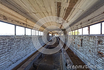 Broken conveyor belt in an abandoned port facility Stock Photo