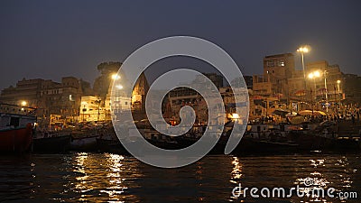 View of buildings of temples with ancient architecture of Varanasi, holy Hindu town, as seen from a moving boat in the Stock Photo