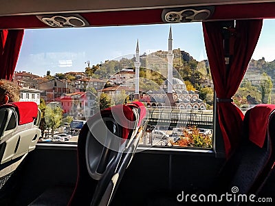 The view from the bus window on the cityscape with a mosque in Ankara Turkey. Modern passenger vehicle interior with red seats Editorial Stock Photo