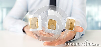 Businessman holding Different size of a smartphone sim card 3d r Stock Photo