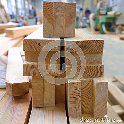 View from butt of stack of three-layer wooden glued laminated timber beams from pine finger joint spliced boards Stock Photo