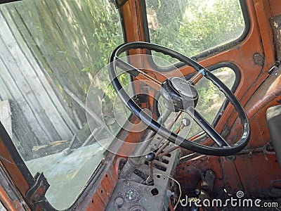 View of the cab of an old tractor. Steering wheel and interior of the cab. Agricultural machinery, selective focus Stock Photo