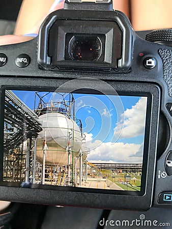 The view of the camera with the photograph is a large round shiny metallic high-pressure container sturdy with pipes Stock Photo
