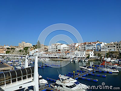 View of the canal port of Ciutadella de Menorca with various boats in the foreground and in the background of the blue sky the Editorial Stock Photo