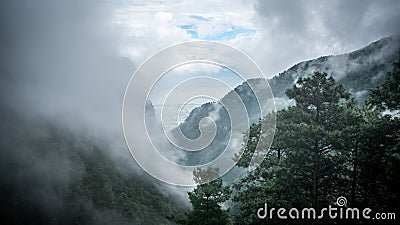 View from Cangshan mountain with green nature and Erhai lake in the distance between the clouds Dali Yunnan China Stock Photo