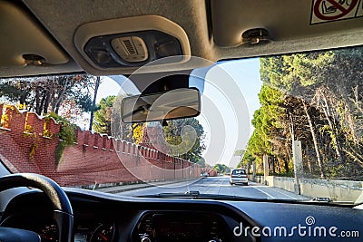 View from car window on the road and strange landscape with a valley, mountains and blue sky with clouds. Landscape through Editorial Stock Photo