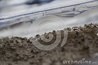 View into the cavity under a frozen puddle Stock Photo