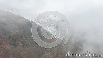 View of the Cayambe volcano glacier going down the slope on a cloudy day Stock Photo