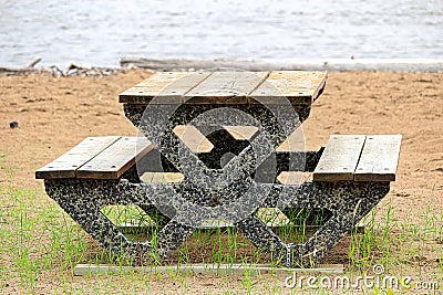 View of a cement picnic table at a beach Stock Photo