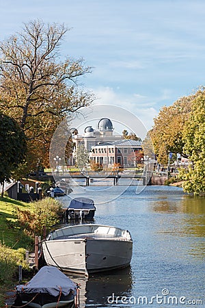 View of the channels of city Leiden, bots and trees, Leiden Observatory background. Stock Photo