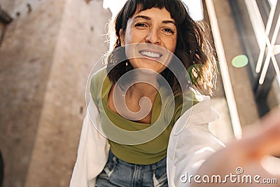 View of cheerful european woman rech her hand and look with smile at camera Stock Photo