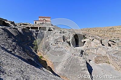 View of Church of Prince and Uplistsikhe Cave Town on Sunny Day Stock Photo