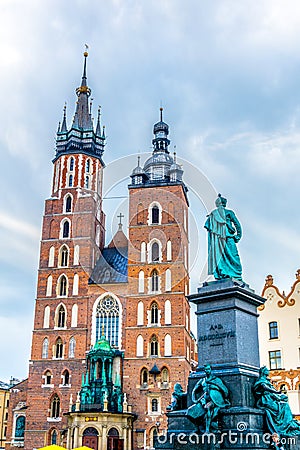 View of the church of Saint Mary with statue of adam mickiewicz in the polish city Cracow/Krakow....IMAGE Stock Photo