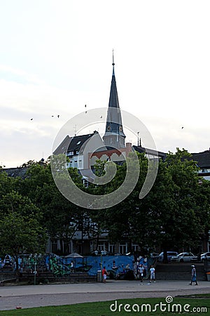 View on the church steeple behind trees in the park in wiesbaden hessen germany Editorial Stock Photo