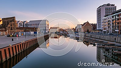 View of city Gdansk at sunrise. The promenade along the riverbank of Motlawa River. Editorial Stock Photo